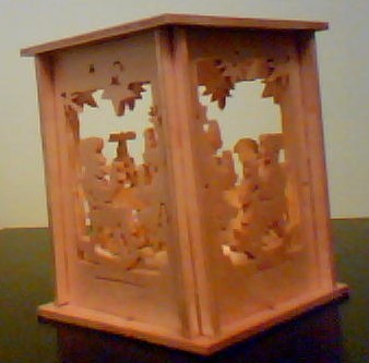 scroll sawed light, approx. size 3" x 3" x 4", natural finish baltic birch, battery tea light included